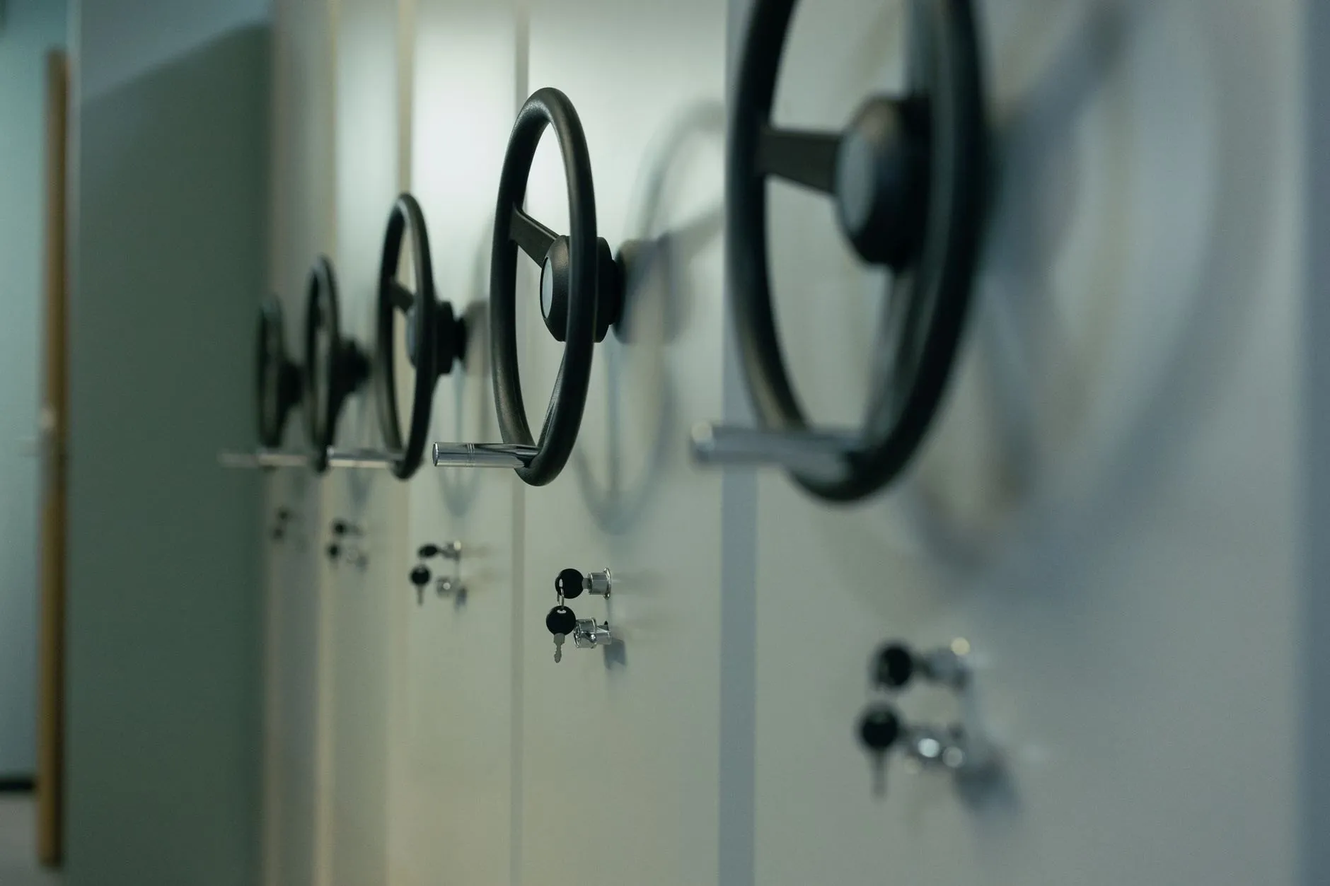 A row of safe doors with large handwheels and keyed locks