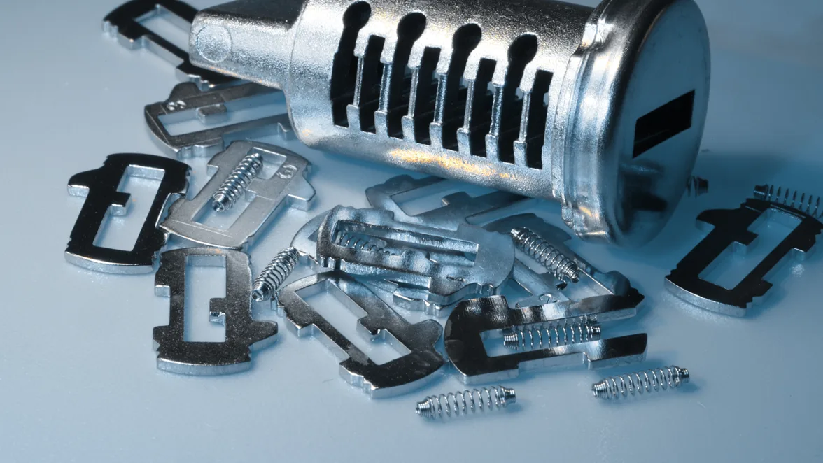 A wafer cylinder opened out on the bench, its wafers and springs laid beside it.