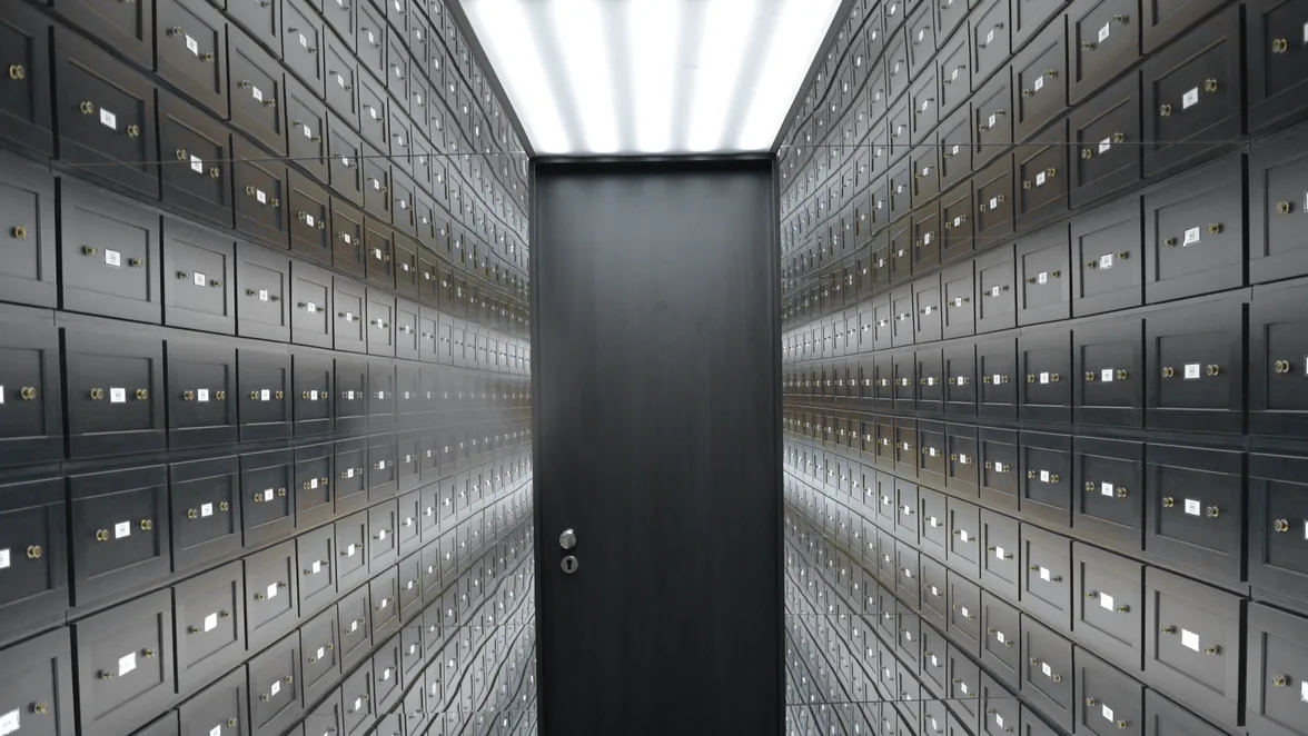 A strongroom lined with deposit boxes.