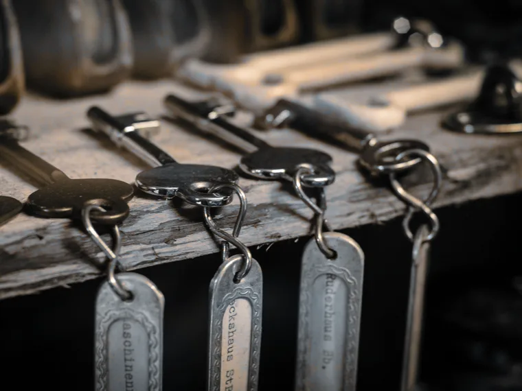 Tagged keys on a rail, one tag per door in a suite.
